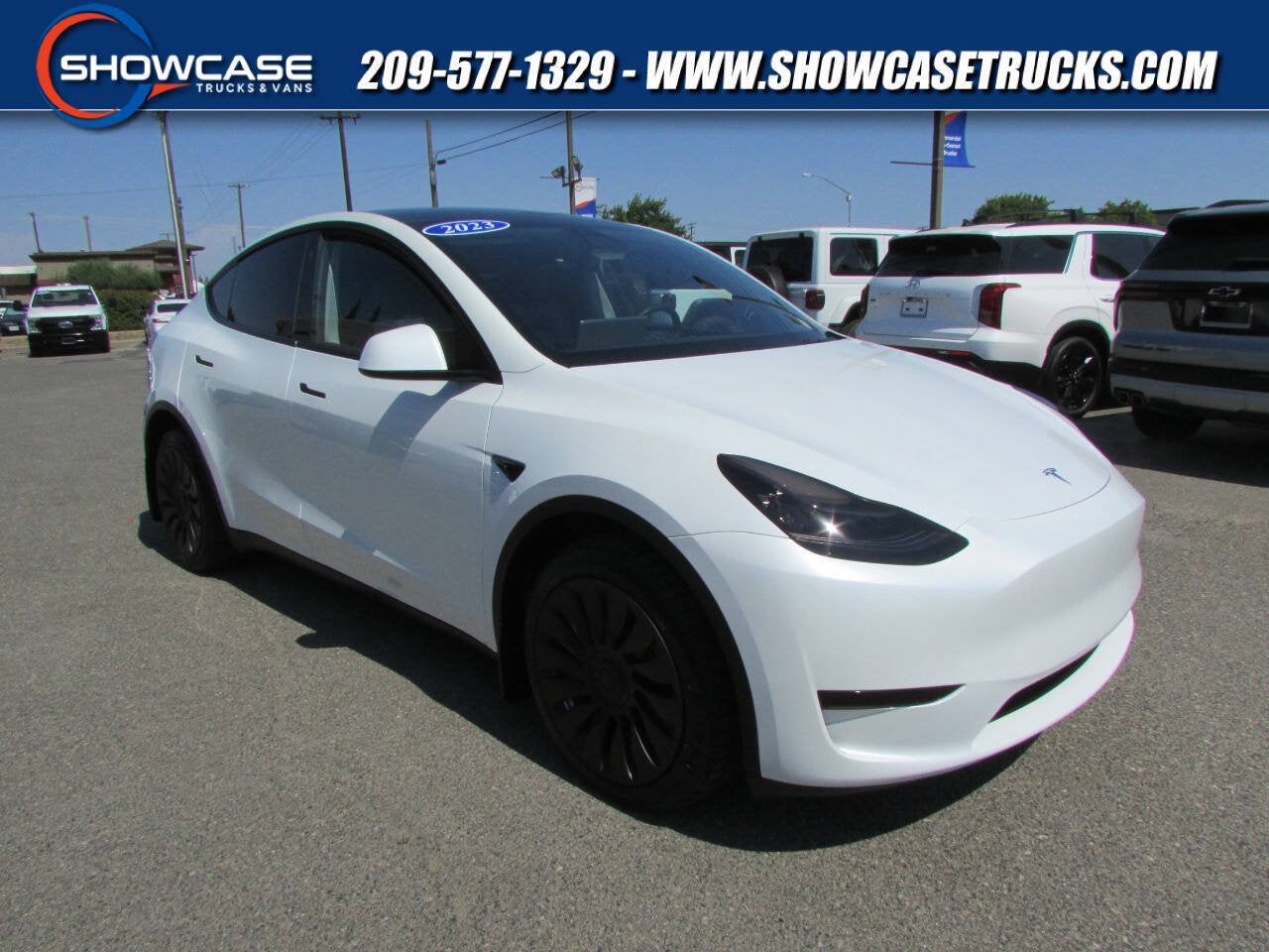 2023 Tesla Model Y Long Range AWD 4dr Crossover in Pearl White Multi-Coat — front three-quarter view